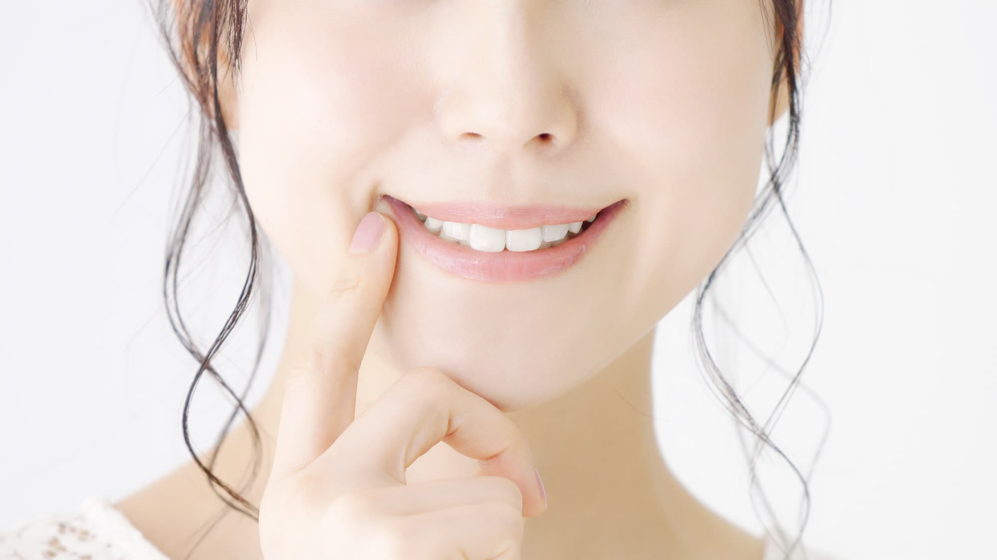 歯を指さす女性